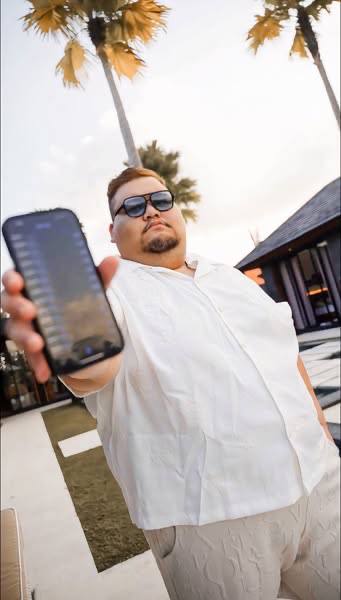 Bob holding his phone outdoors